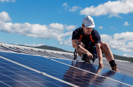 Solar technician installing solar panels